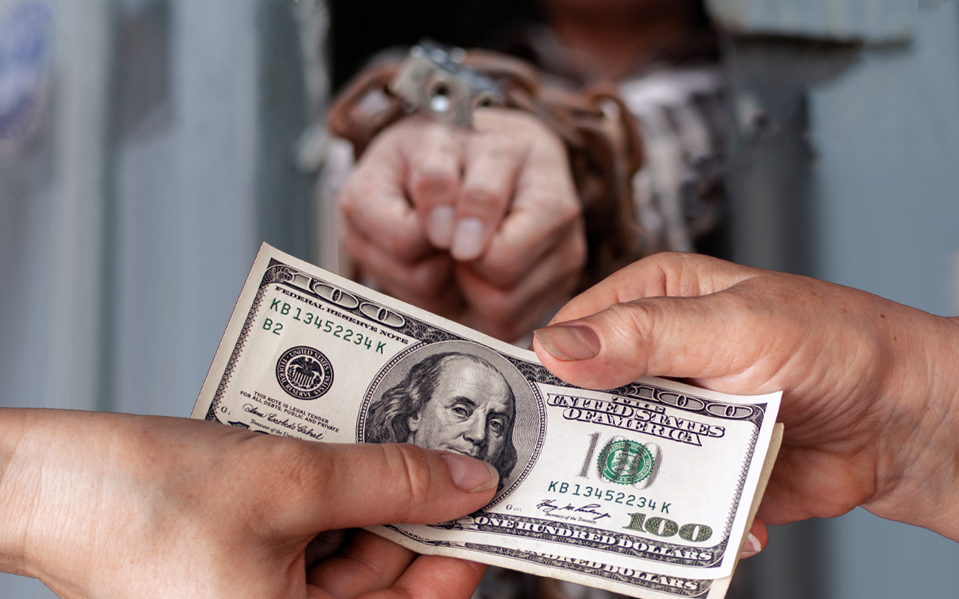 bounds hands behind dollars being exchanged