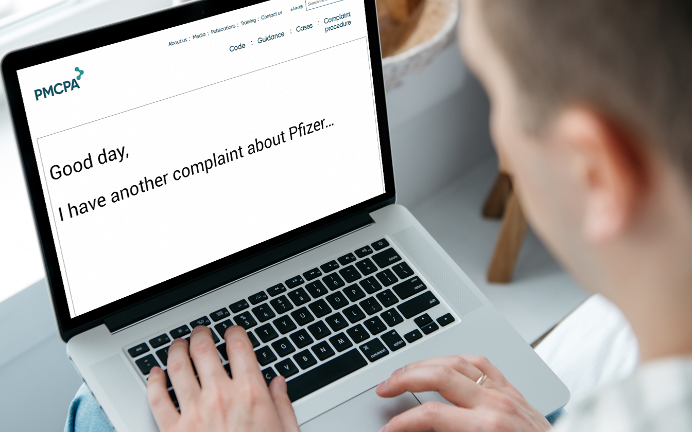 Man typing into compute "I have a another compliant about Pfizer"