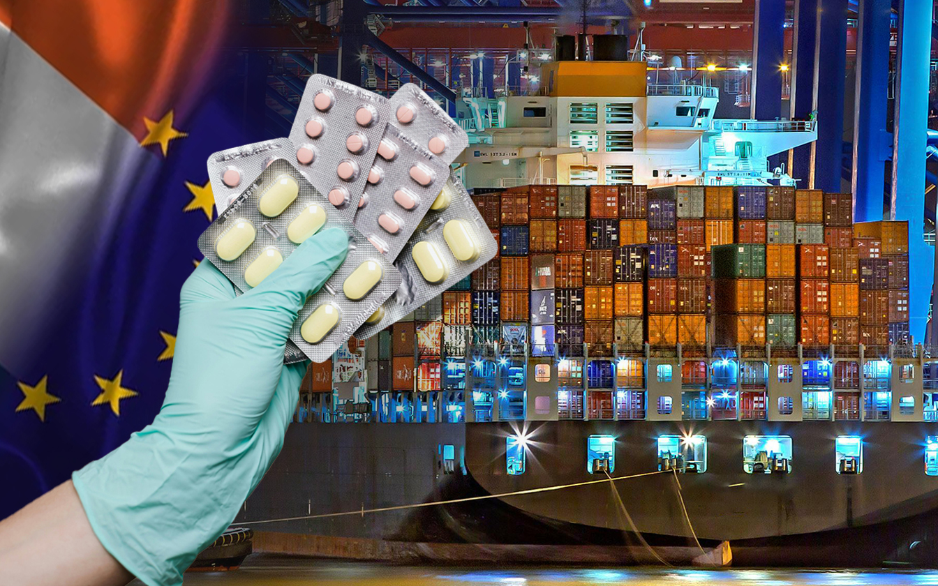 Hand holding tablets with shipping tanker behind